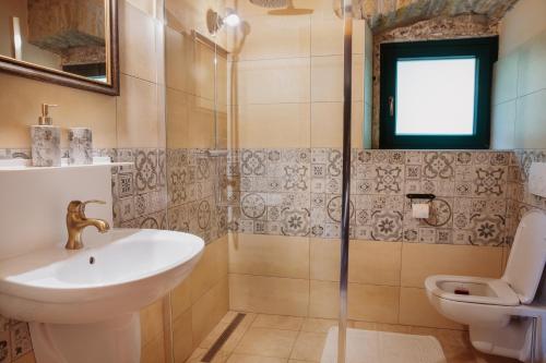 a bathroom with a sink and a toilet at Apartmaji Pajer in Koper