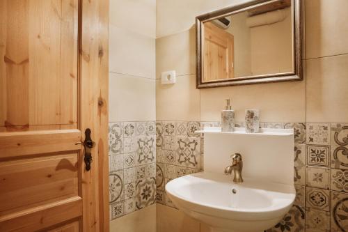 a bathroom with a sink and a mirror at Apartmaji Pajer in Koper