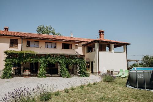 a house with vines growing on the side of it at Apartmaji Pajer in Koper