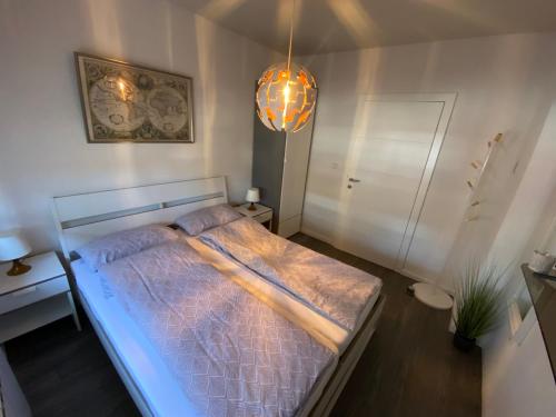 a bedroom with a bed and a pendant light at Guesthouse Old Town in Sarajevo