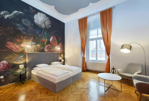 a bedroom with a bed and a painting on the wall at Boutique Hotel Dom - Rooms & Suites in Graz