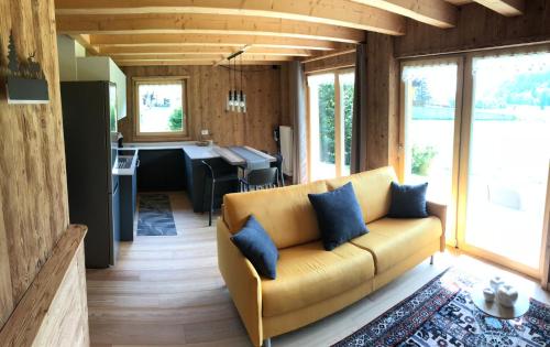 a living room with a couch and a kitchen at Chalet Camporosso Rosenstein in Camporosso in Valcanale