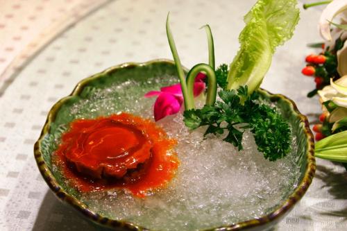 a plate of food with red sauce on a table at Jianguo Hotel Guangzhou in Guangzhou
