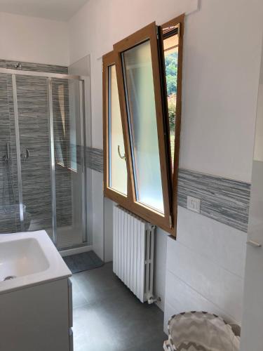 a bathroom with a sink and a window at Mati's House in Bellagio
