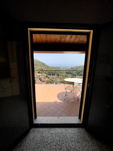 a door leading to a patio with a table outside at Casa del Borgo in Isca sullo Ionio