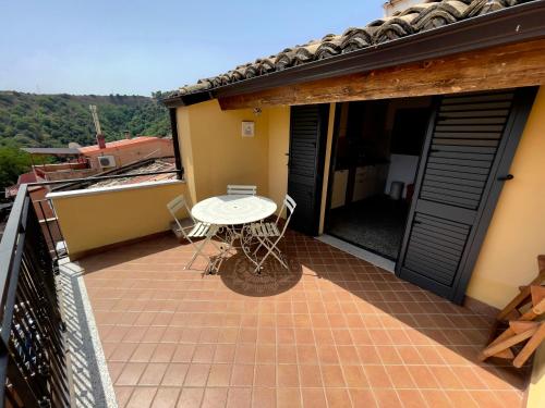 a patio with a table and chairs on a balcony at Casa del Borgo in Isca sullo Ionio