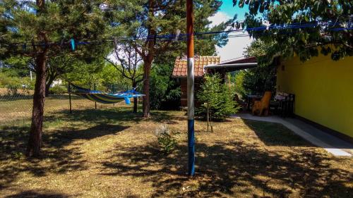 a hammock in a yard next to a house at Apartment Franciska in Rakovica