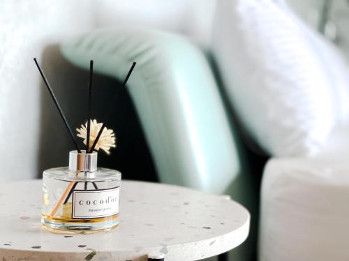 a perfume bottle on a table next to a couch at Noah's Ark Homestay in Huxi