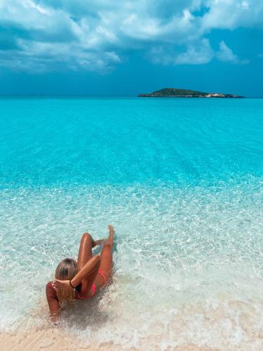a woman laying in the water on a beach at Tropical View Villas in Hartswell