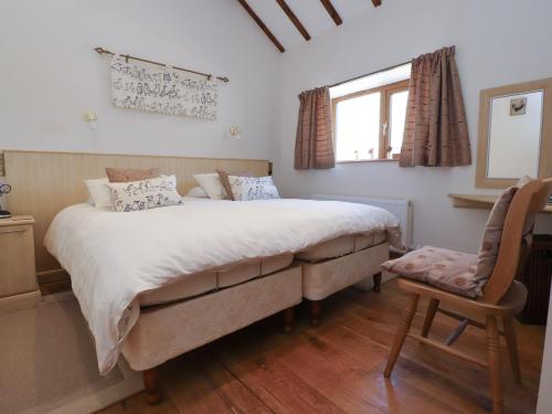 a bedroom with a large bed and a chair at The Proven House in Preston