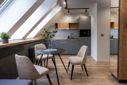 a kitchen and dining room with a table and chairs at Minaret Residence & Relax Pécs in Pécs