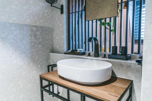 a bathroom with a white sink and a mirror at SoHotel in Schagen