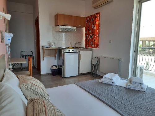 a room with a kitchen with a stove top oven at Ntemos Apartments in Tolo