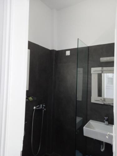 a bathroom with a shower and a sink at Three Harites in Perissa