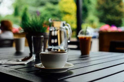a cup of coffee sitting on a wooden table at Abbey Court in Nenagh