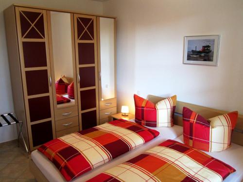 ein Schlafzimmer mit zwei Betten und einem Schrank in der Unterkunft Haus Ostseeduo FeWo Nr. 4 in Bansin
