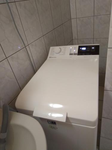 a white toilet in a small bathroom with a white toilet at Kiss Apartman in Balatonberény