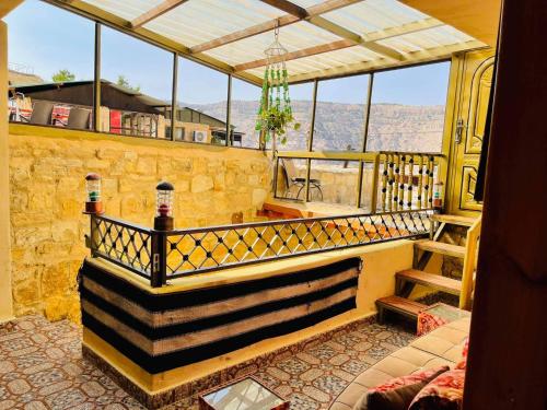 a room with a balcony with views of the mountains at Dana Gate Lodge in Dana