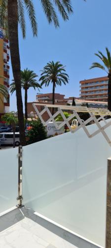a white skateboard ramp with palm trees in the background at Babylon Tourist Apartments in Benalmádena