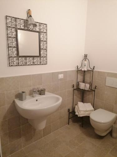 a bathroom with a sink and a toilet and a mirror at Ferrari Formula 1 in Orio al Serio