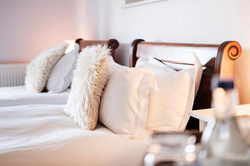 two white pillows on a bed with white sheets at The Bower Inn in Bridgwater