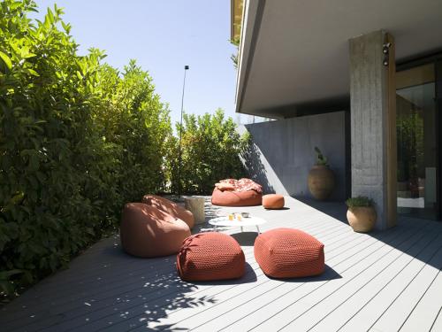 a group of ottoman chairs sitting on a patio at Criu Boutique Hotel in Nicolosi