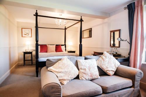 a living room with a couch and a bed at The Bower Inn in Bridgwater