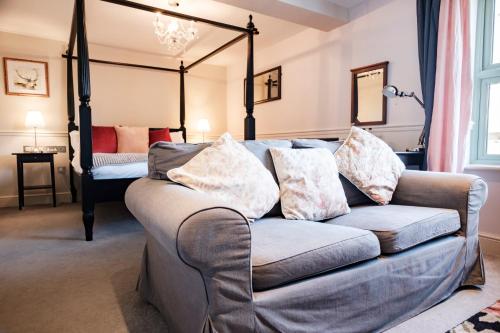 a living room with a couch and a bed at The Bower Inn in Bridgwater