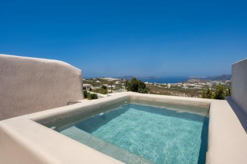 a swimming pool on the side of a house at Phaos 1870, A restored Winery in Pirgos