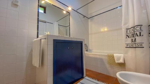 a bathroom with a blue door next to a sink at Casa de São Vicente de Cima in Póvoa de Lanhoso