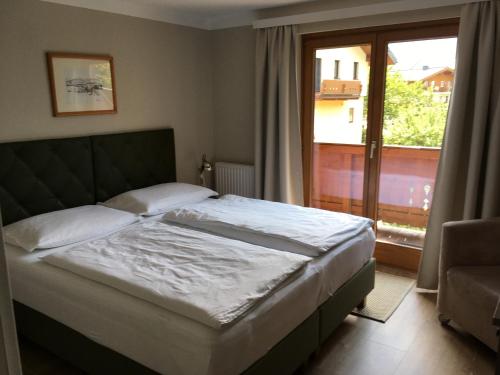 湖畔捷爾的住宿－Appartement Kitzsteinhorn，一间卧室设有一张床和一个大窗户