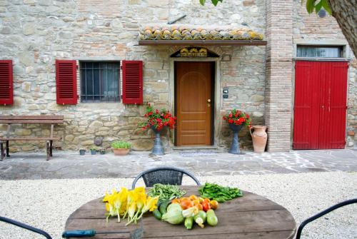 a table with vegetables on it in front of a building at Casa Donella B&B in Gricignano