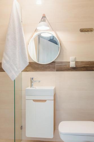 a bathroom with a sink and a mirror at Pod Jasną 28 in Częstochowa