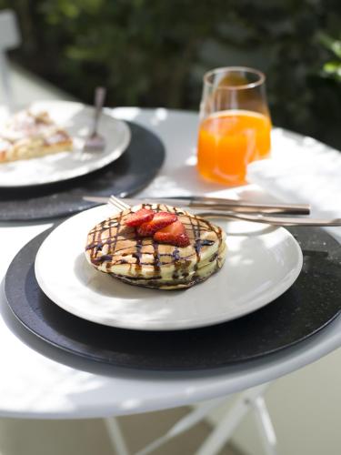 a table with two plates of food on top at Criu Boutique Hotel in Nicolosi