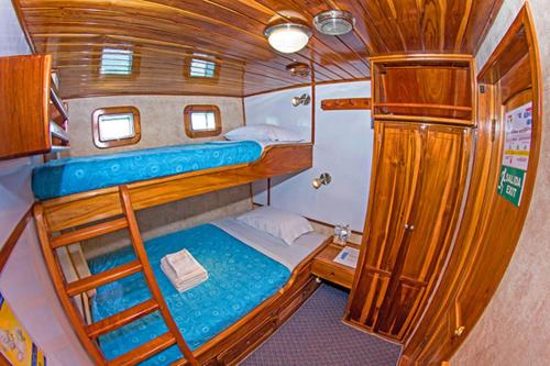 a small room with two bunk beds on a boat at Cruise Ship Southern Star At Dock Only in Bahía de Caráquez