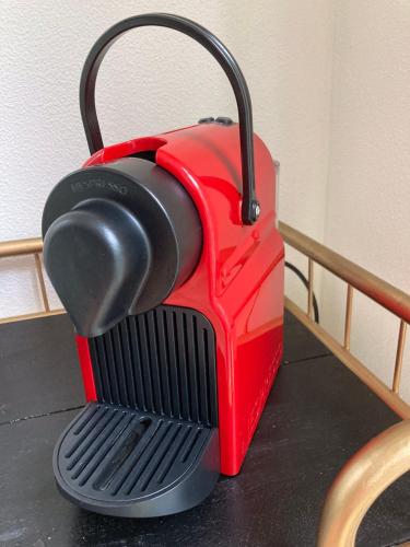 a red and black purse sitting on a table at het zwaluwnest in Koudekerke