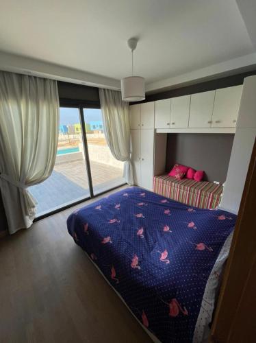 a bedroom with a bed and a view of the beach at Bo Islands villa in El Alamein