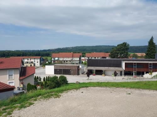 a group of buildings in a town with a road at Hôtel le Comtois in Saône
