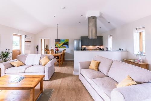 a living room with two couches and a table at Brecks Farm - Cow Kennels in York