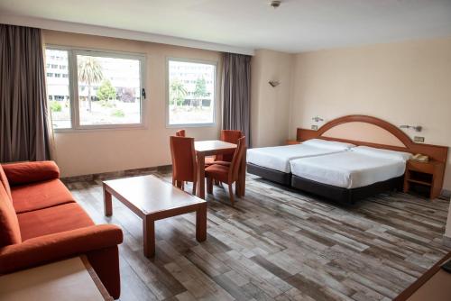 a hotel room with a bed and a table at Hotel Palacio del Mar in Santander