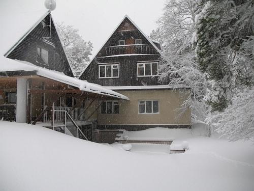 a house covered in snow in front at Laugu Guesthouse in Kuusalu