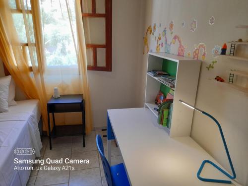 a small room with a desk and a bed at Antoine Apartment Sea Side in Tsoútsouros