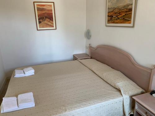 a bed in a room with two towels on it at Luna e stelle in Sangineto