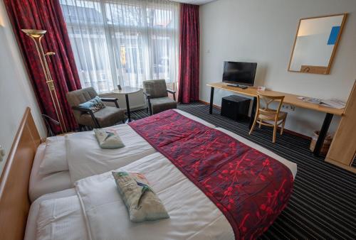 Een bed of bedden in een kamer bij Hotel de Branding