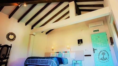 a room with a bed and a blue door at Casona Granado in El Pilar y Provincias