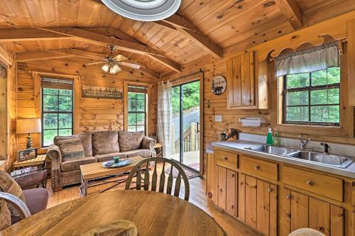 a kitchen and living room in a log cabin at Quaint Log Cabin with Views Near West Jefferson in Warrensville
