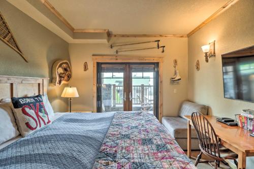 a bedroom with a bed and a desk and a table at Ski-InandSki-Out Whitefish Escape with Balcony! in Whitefish