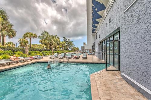 a person in a swimming pool in a house at 10th-Floor Condo on Myrtle Beach with Pools! in Myrtle Beach