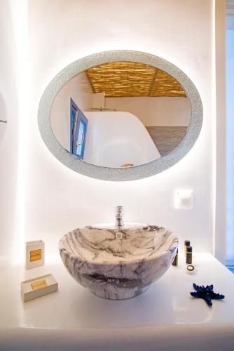 a bathroom with a marble sink and a mirror at La Belle Vie - Santorini - Adults Only in Kamari