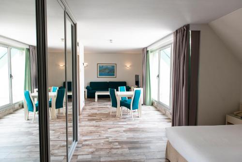 a hotel room with a bed and a table and chairs at Hotel Palacio del Mar in Santander